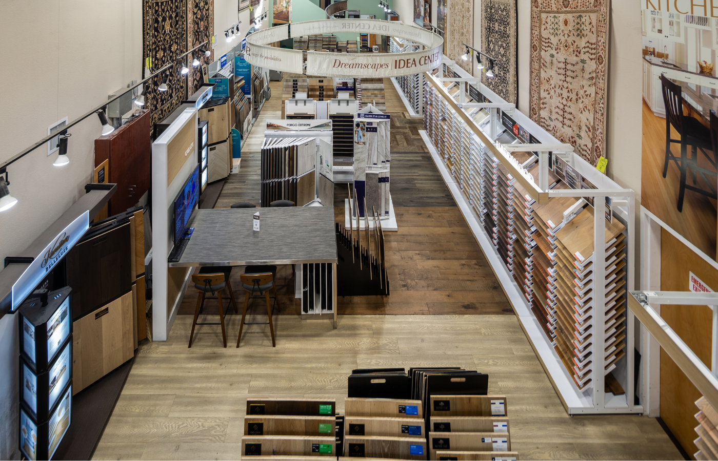 Floorscapes showroom in Albuquerque with hardwood, luxury vinyl, carpet, and tile flooring displays, organized sample racks, and design inspiration wall.