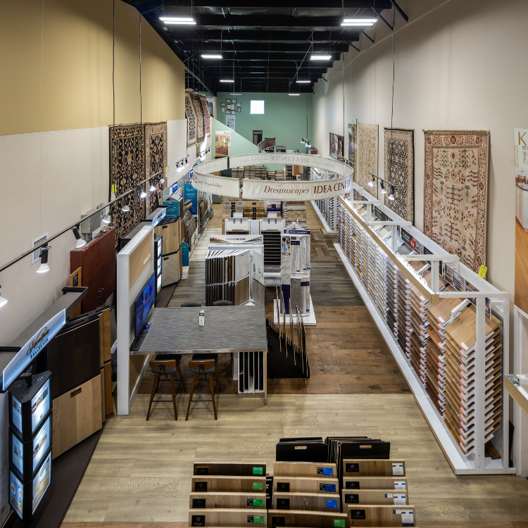 Floorscapes showroom in Albuquerque with hardwood, luxury vinyl, carpet, and tile flooring displays, organized sample racks, and design inspiration wall.